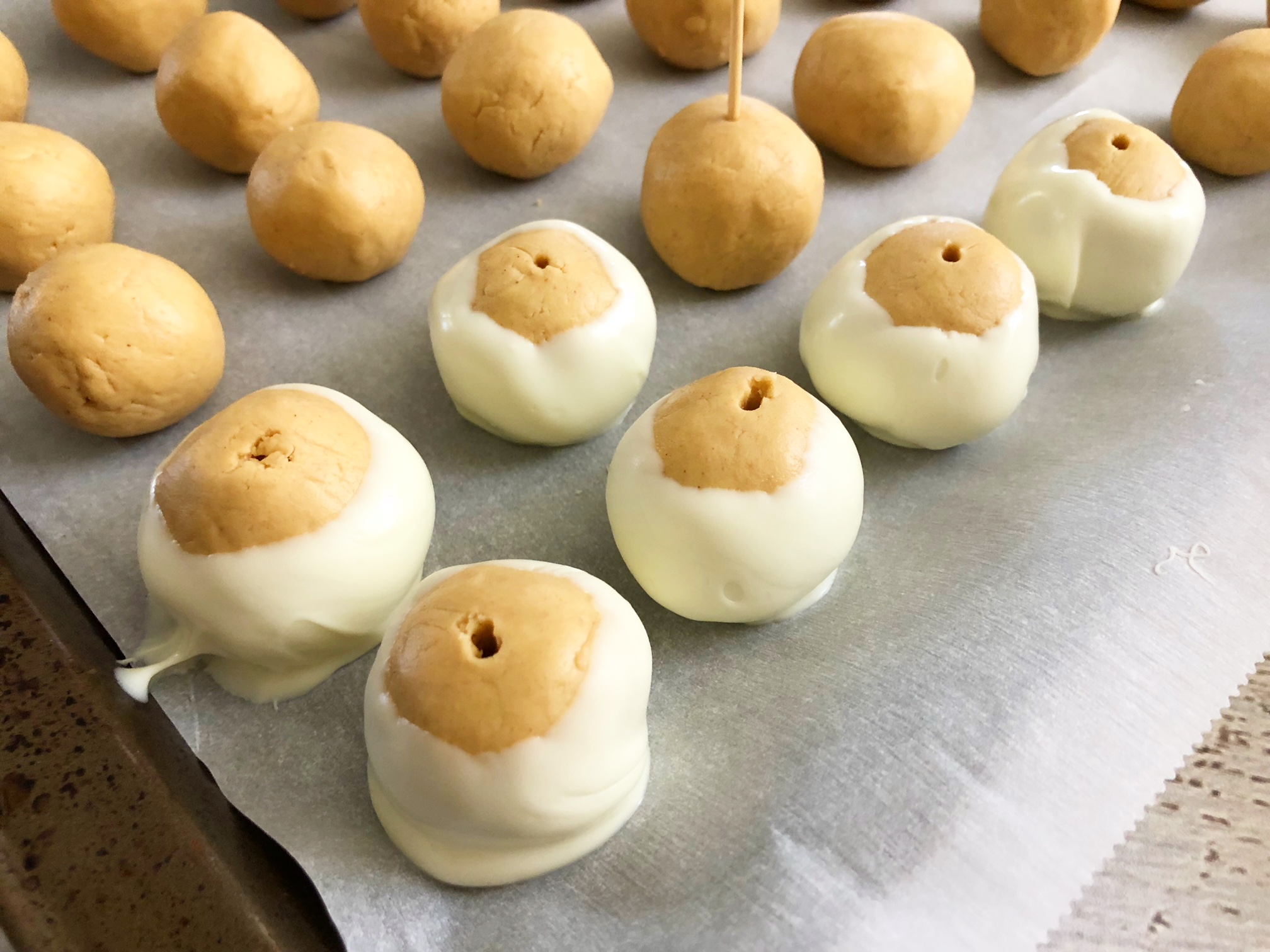 Let the white chocolate set on the balls before decorating